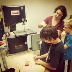 Jake and Kami teach XXX how to use the saw. He jumped right on it with a huge grin and cut away about a minute after this was shot. Easy peasy.