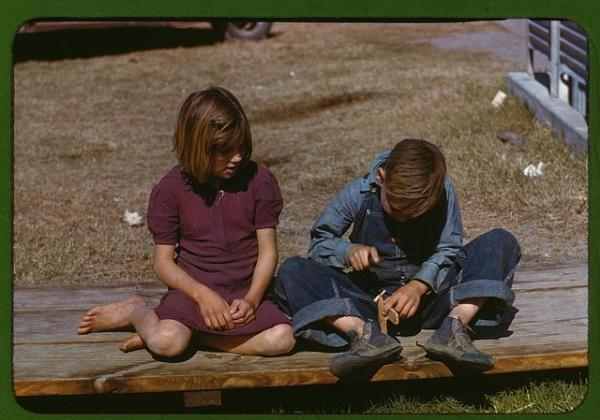 Boy building a model airplane at a Farm Security Administration (FSA) camp. Initially created as the Resettlement Administration (RA) in 1935 as part of the New Deal in the United States, the FSA was an effort during the Depression to combat American rural poverty. The kids stayed busy as well.
