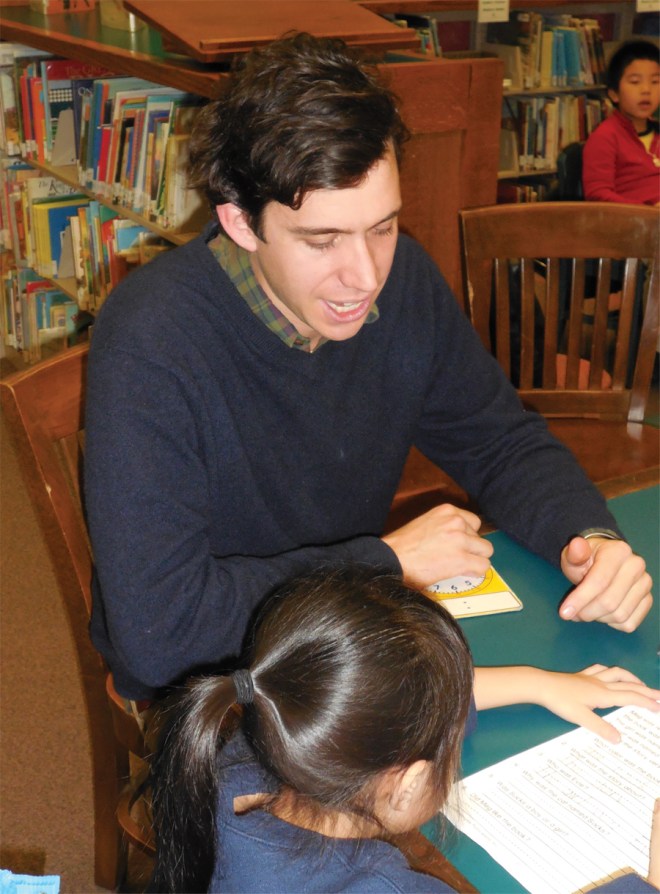 Joseph working with a student at the McKinley Branch Library.