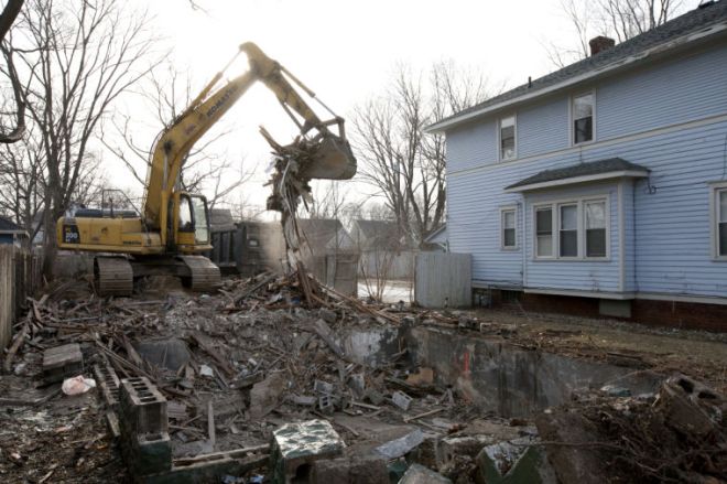 A home is demolised in a Near Northwest neighborhood. The demo is part of the city's push to address 1,000 vacant homes in 1,000 days. (South Bend Times photo by James Brosher)